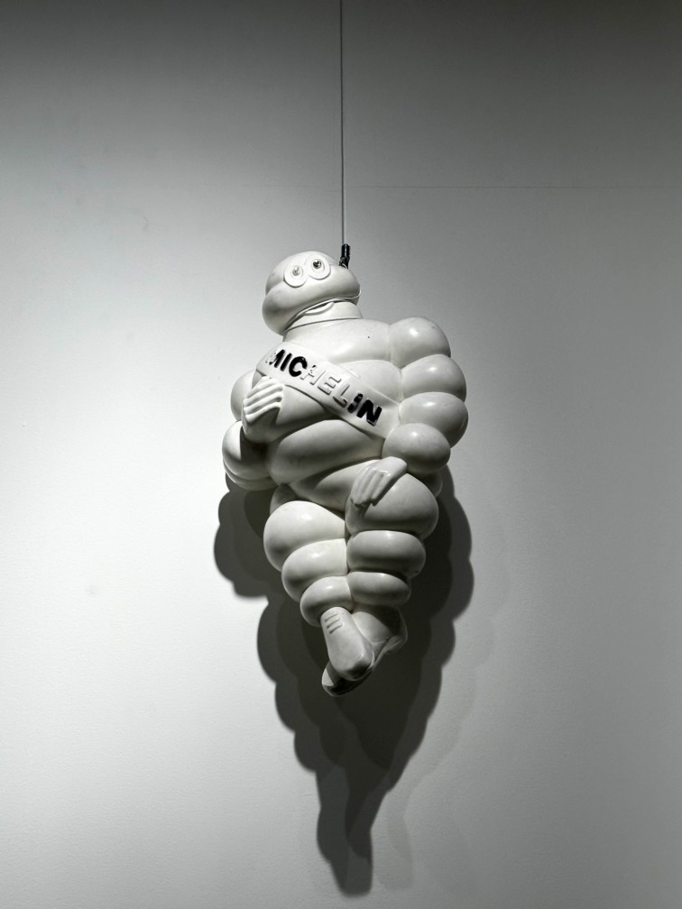 Michelin Man figure hanging on a wall