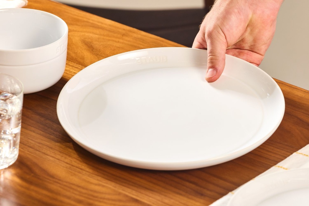 Plate held on a wooden table